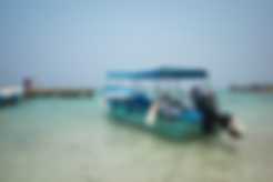 A boat docked at the beach in Roatan, Honduras