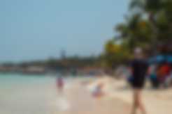 A man jogging on the beach in Roatan, Honduras