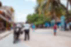 A police officer surveying the street in Mahahual, Costa Maya, Mexico
