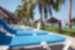 Beach chairs lined up next to the pool at Nachi Cocom in Cozumel, Mexico
