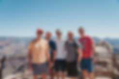 Friends taking a photo in front of the Grand Canyon